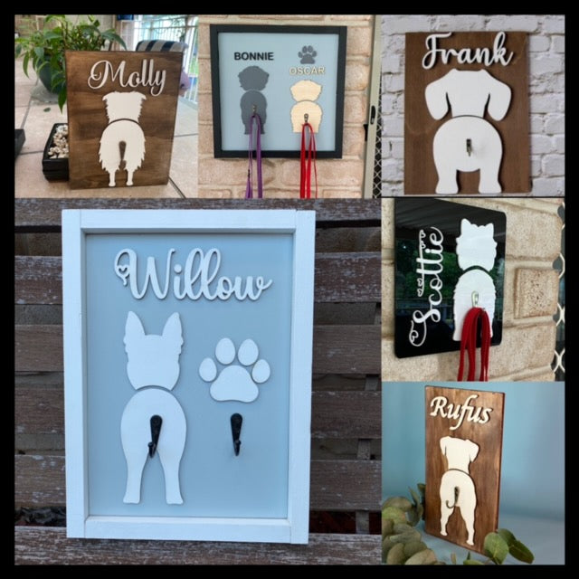 A selection of dog leash holders some with frames, acrylic and all timber designs.