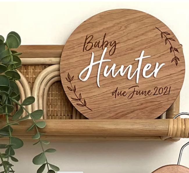 15 centimetre Announcement disc , engraved with  Baby Hunter due June 2021 is a plywood circle.  The baby's name is done in white 3mm acrylic in a handwritten font giving a 3D effect.   Sold by Bubs and Bobbins.